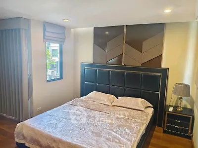 Luxurious bedroom with elegant decor and large window for natural light