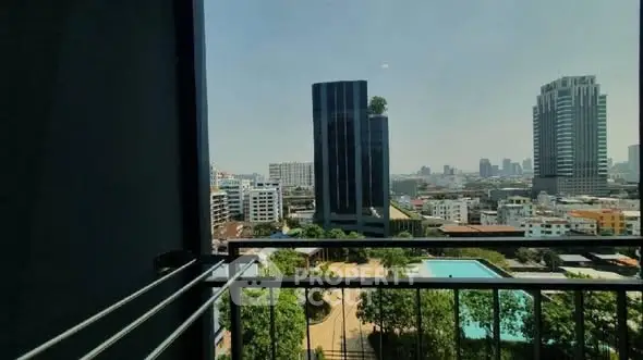 Stunning cityscape view from a high-rise balcony overlooking a pool and skyline.