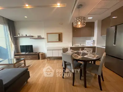 Modern open-layout living room and kitchen with elegant dining area and stylish decor.
