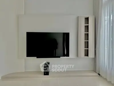 Modern living room with sleek TV setup and natural light