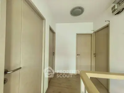 Modern hallway with wooden doors and minimalist design