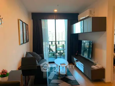 Modern living room with stylish decor and balcony view in a high-rise apartment.