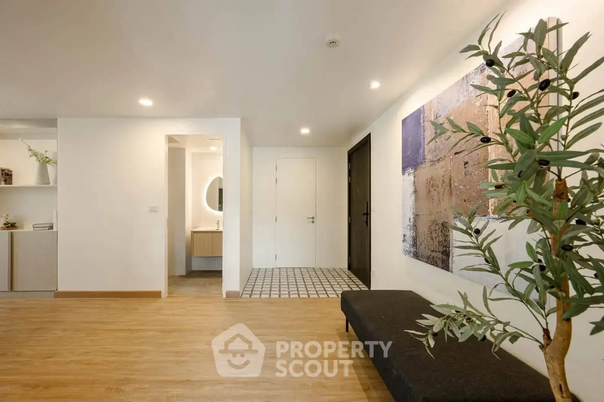 Modern apartment entrance with stylish decor and wooden flooring