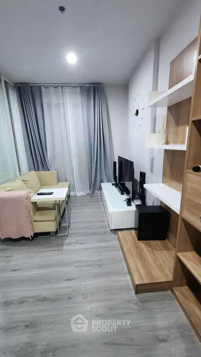 Modern living room with sleek furniture and stylish decor, featuring a cozy corner sofa and entertainment center.