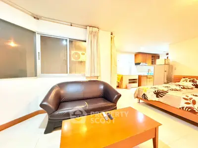 Cozy studio apartment with modern furnishings and open kitchen layout