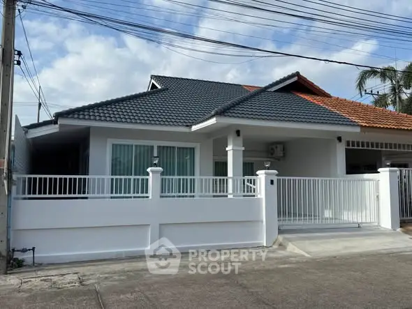 Charming single-story house with modern design and spacious front yard in a serene neighborhood.