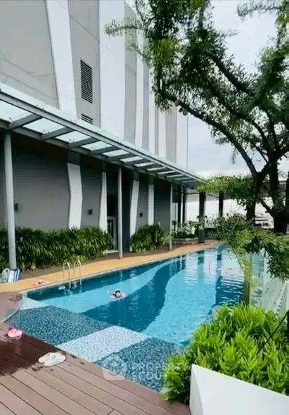 Luxurious modern apartment pool with lush greenery and sleek design