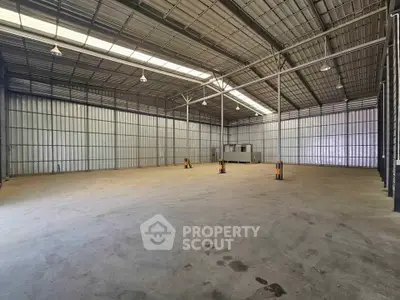 Spacious industrial warehouse with high ceilings and ample storage space.