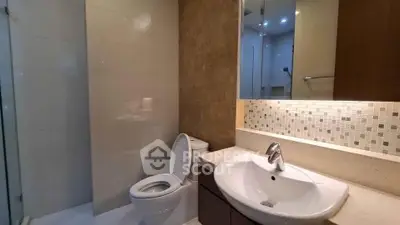 Modern bathroom with sleek sink and tiled backsplash