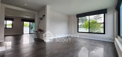 Spacious modern living room with large windows and sleek flooring