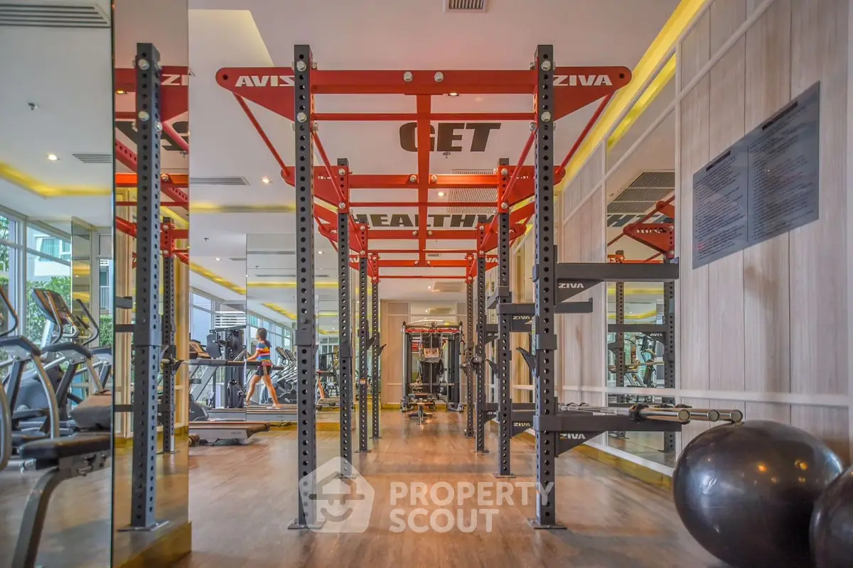 Spacious modern gym with state-of-the-art equipment and mirrored walls.
