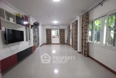 Spacious living room with large windows and modern decor