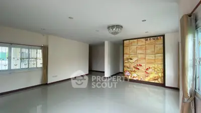 Spacious living room with elegant wall art and large windows