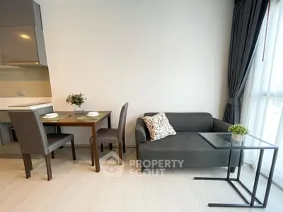 Modern living room with dining area and sleek furniture in a bright apartment.