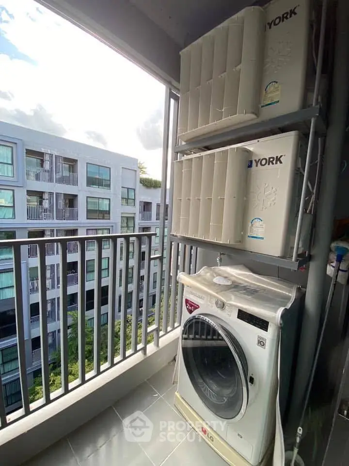 Modern apartment balcony with washing machine and air conditioning units