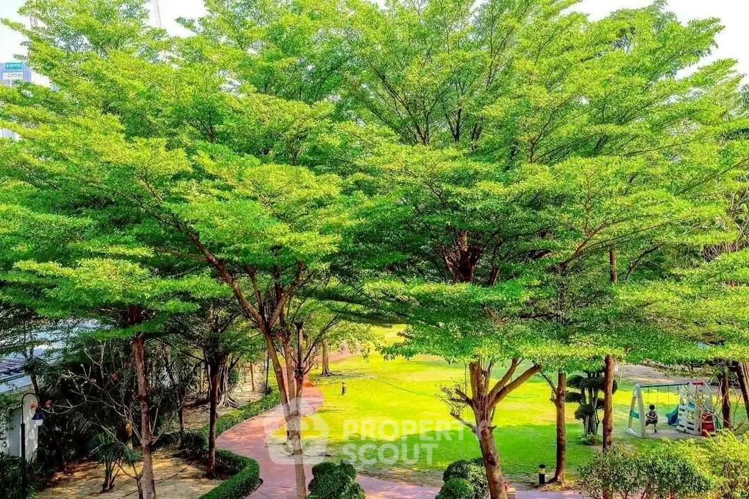 Lush green garden with walking paths and vibrant trees in a serene setting.