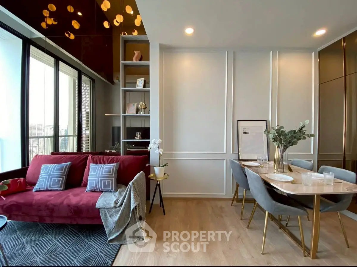 Modern living room with elegant dining area and city view, featuring stylish decor and cozy ambiance.