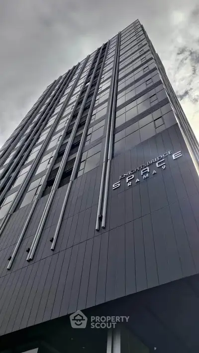 Modern high-rise building with sleek architectural design and glass facade.