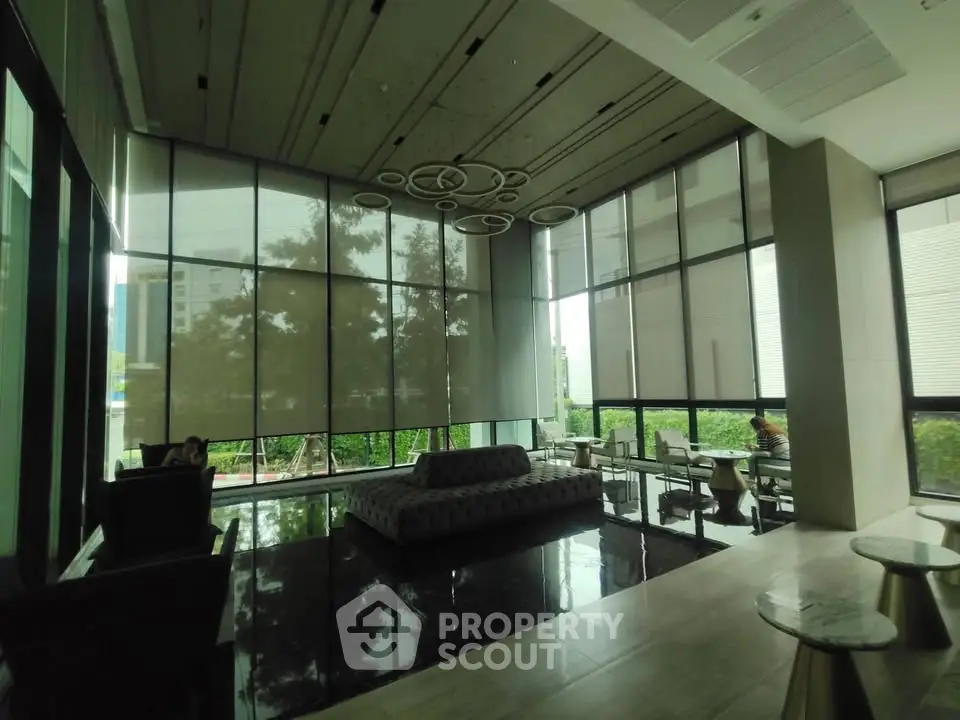 Luxurious modern lobby with high ceilings and stylish seating in a contemporary building.