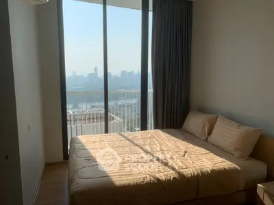 Modern bedroom with large windows offering stunning city views and natural light.