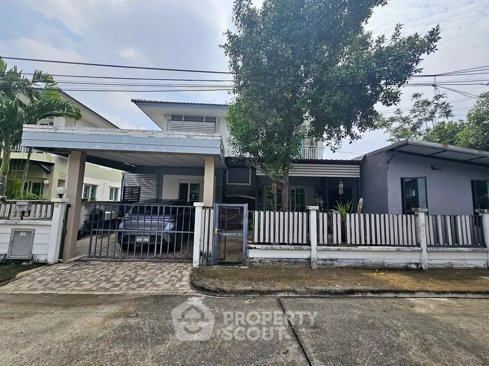 Charming suburban home with spacious driveway and lush greenery, perfect for family living.