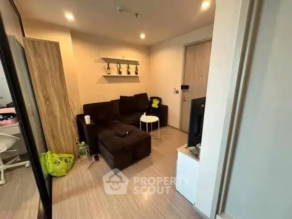 Cozy living room with modern decor and comfortable seating in a stylish apartment.