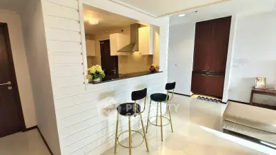 Modern open kitchen with bar stools and sleek design in stylish apartment