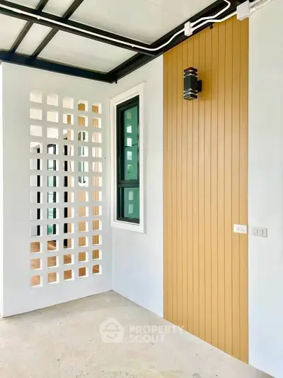 Modern balcony with stylish wooden paneling and unique lattice wall design.