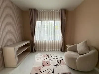 Modern living room with stylish furniture and large window, perfect for natural light lovers.