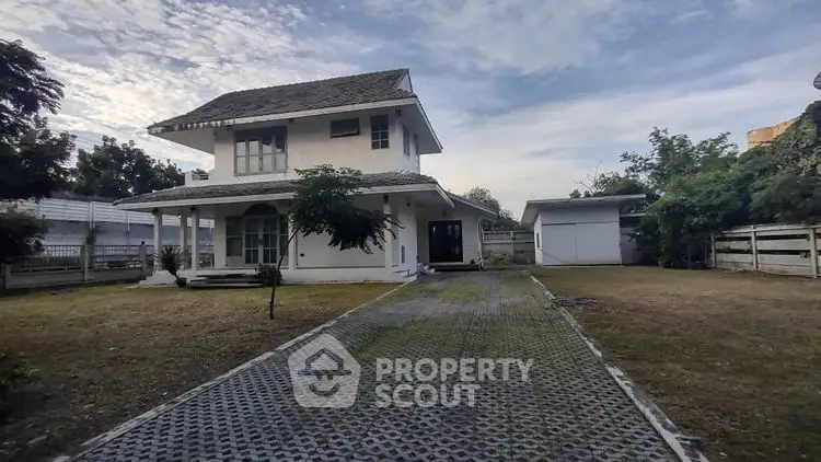 Charming two-story house with spacious driveway and lush garden