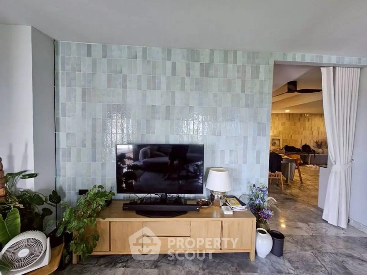 Modern living room with stylish TV stand and tiled accent wall