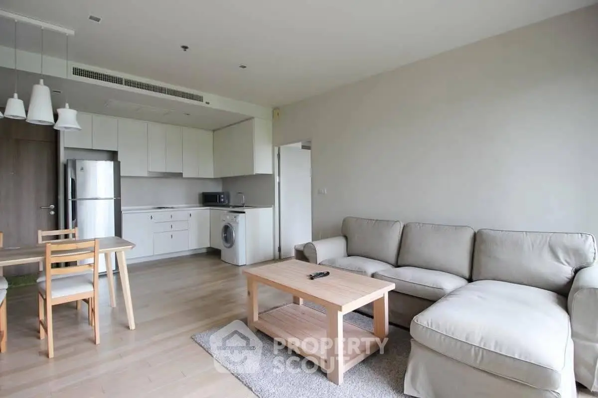 Spacious modern living room with open kitchen and cozy seating area