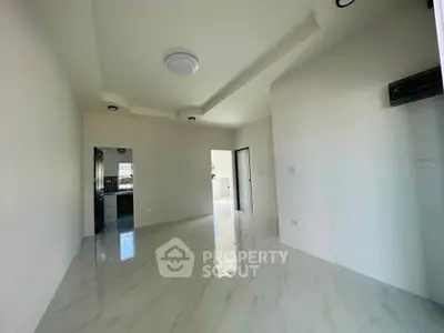 Spacious modern living room with sleek marble flooring and elegant ceiling design.
