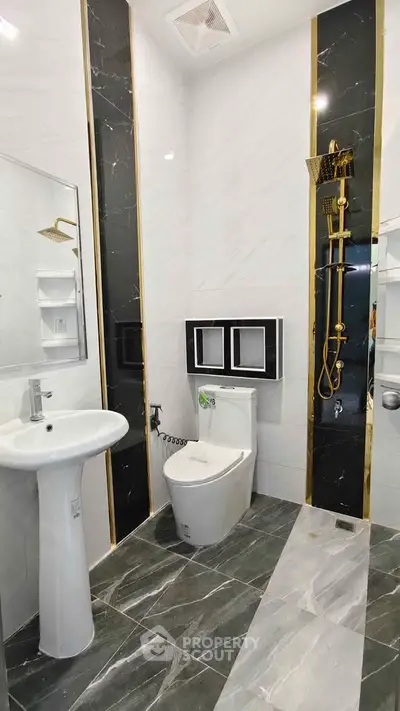 Luxurious modern bathroom with elegant gold accents and sleek fixtures