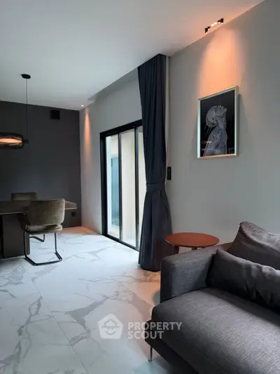 Modern living room with elegant decor and large windows for natural light.