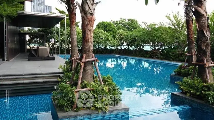 Luxurious outdoor pool area with lush greenery and modern design, perfect for relaxation and leisure.
