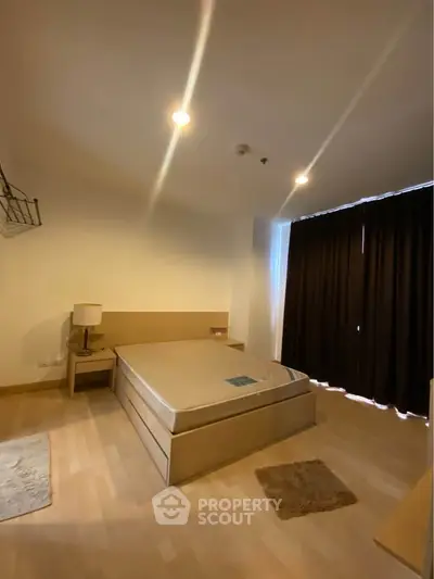 Spacious bedroom with modern furnishings and cozy lighting in a stylish apartment.