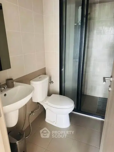 Modern bathroom with sleek shower and contemporary fixtures in a stylish apartment.