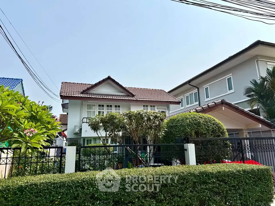 Charming suburban house with lush garden and classic architecture