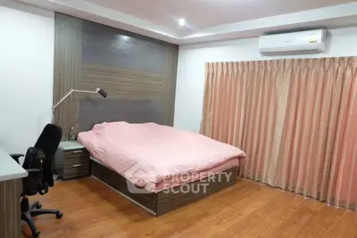 Modern bedroom with wooden flooring and stylish decor