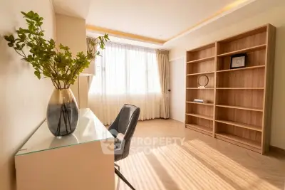 Bright study room with elegant desk and large bookshelves, perfect for productivity.