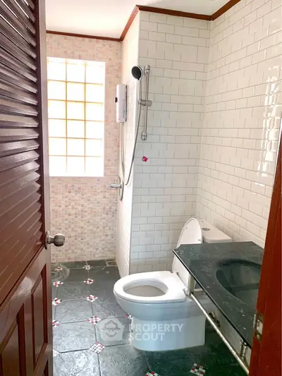 Charming bathroom with modern shower and elegant tile design