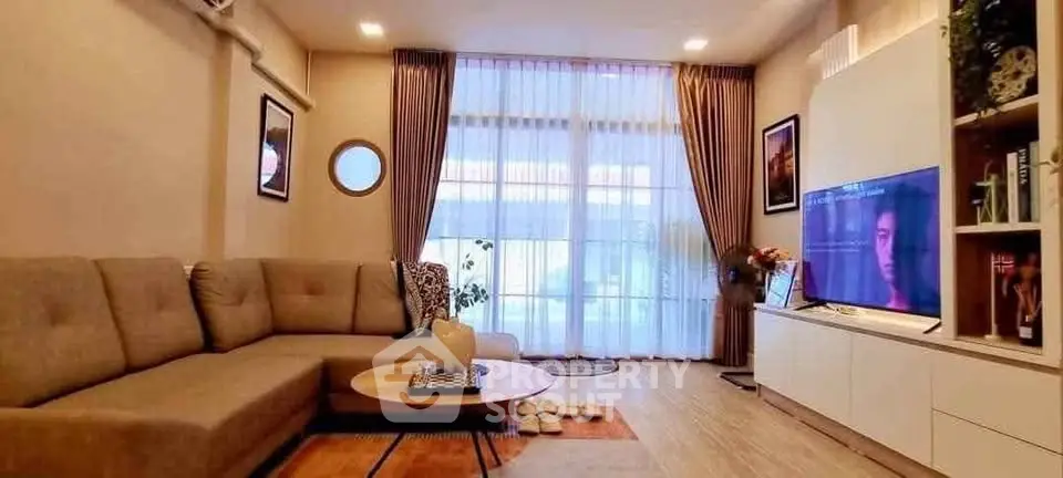 Spacious living room with modern decor and large windows for natural light.