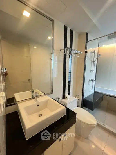 Modern bathroom with sleek fixtures and glass shower enclosure