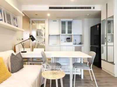 Modern open-plan living room and kitchen with stylish decor and ample natural light.