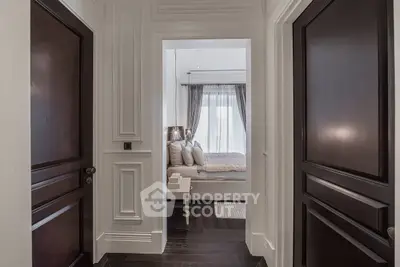 Luxurious bedroom entrance with elegant dark wood doors and stylish decor