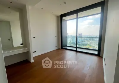 Spacious bedroom with stunning city view and large window in modern apartment