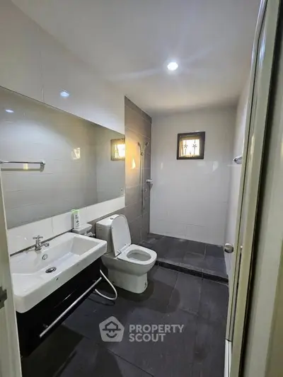 Modern bathroom with sleek fixtures and spacious shower area