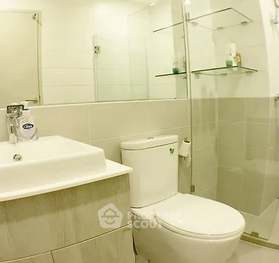 Modern bathroom with glass shower and sleek fixtures in a contemporary apartment.
