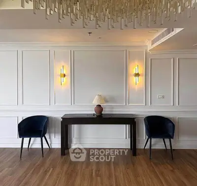 Elegant interior with modern lighting and stylish seating in a sophisticated living space.